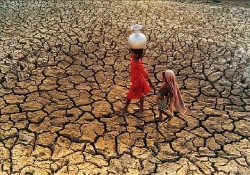 two little sisters on a dry cracked land