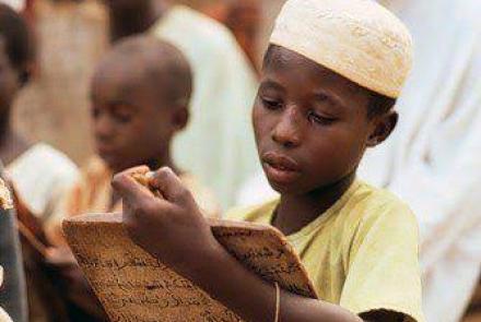 A young Muslim boy with writing materials 