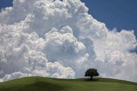 Landscape: a sunny cloud over a hill
