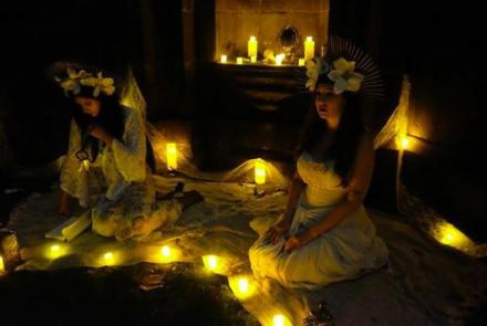 women sitting in fairy lights