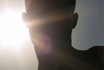 sun reflecting the a man