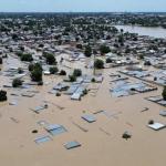 a town that is flooded up to the roof of the houses